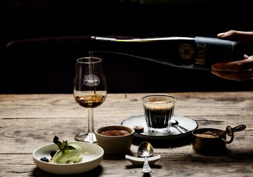 Rare Whisky Cask Ownership Regal Cask's three whisky investment tiers: Blue-Chip Core with gold cask and stability chart; Growth Portfolios showing green upward arrow; Club-Exclusive featuring premium tasting glass—all against elegant dark oak whisky warehouse texture with golden lighting.